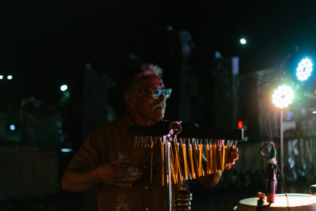 Órale Band percussionist playing a guiro on stage