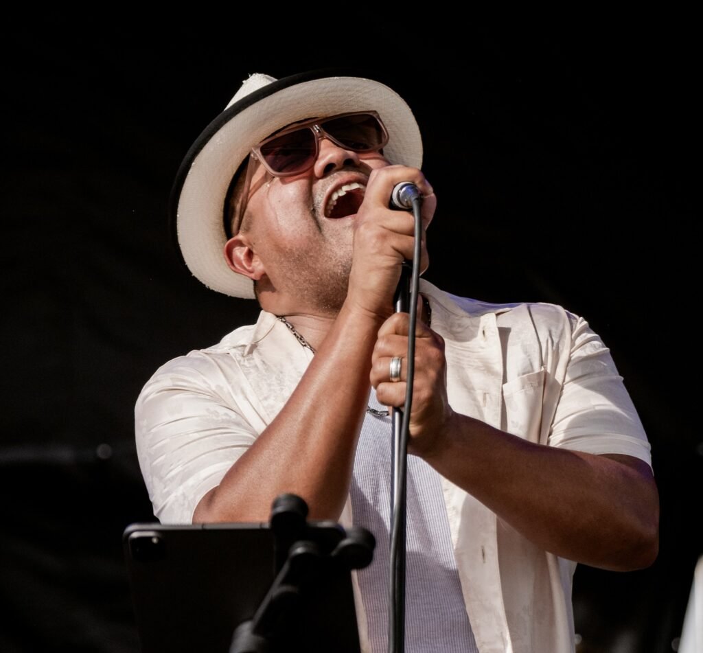 Koki, vocals and percussion for Órale Band