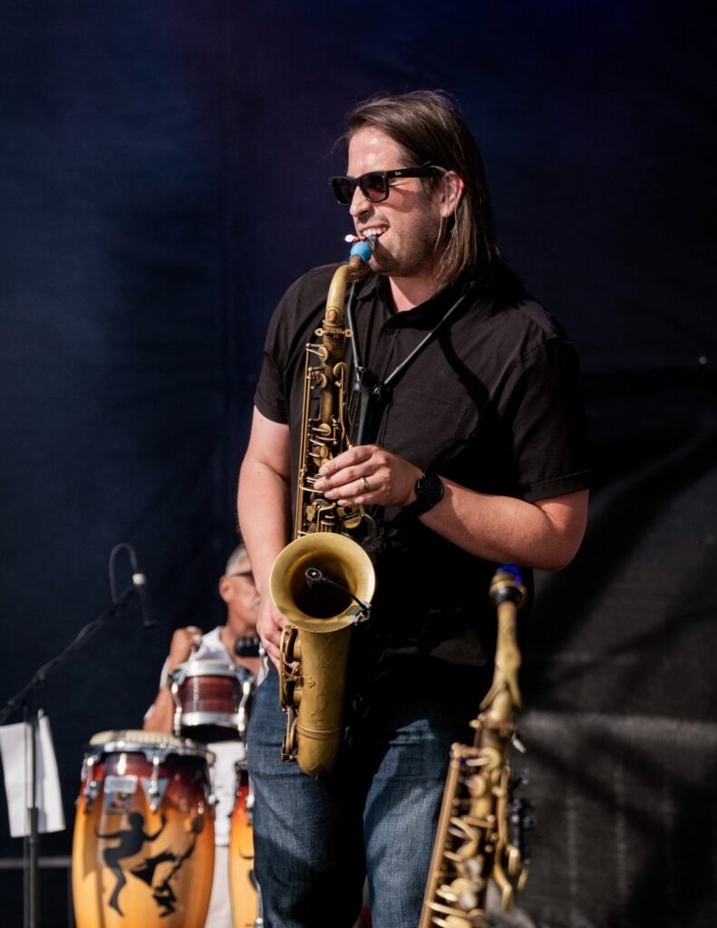 Órale Band saxophone solo during a live outdoor set